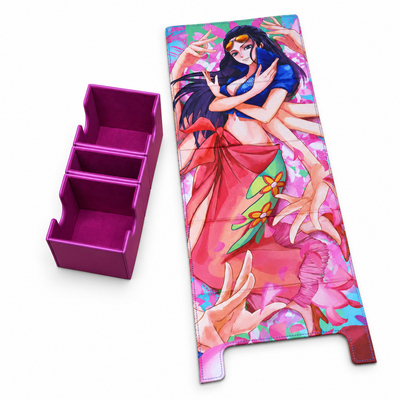A rectangular anime-style printed mat or cover with a colorful illustration of a woman in blue and red clothing, shown next to a separate magenta three-compartment organizer on a plain white background.